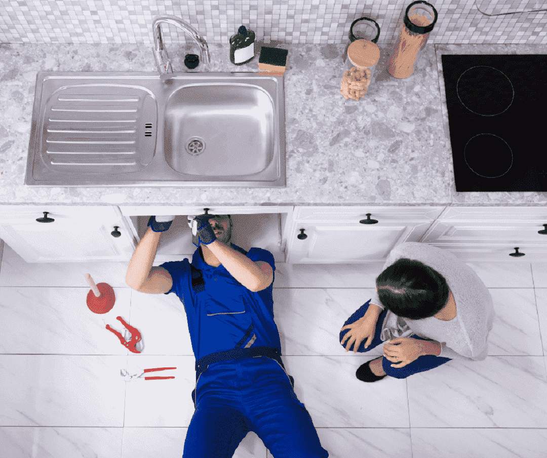 thợ khoan bắt vít để lắp đặt chậu rửa bát inox